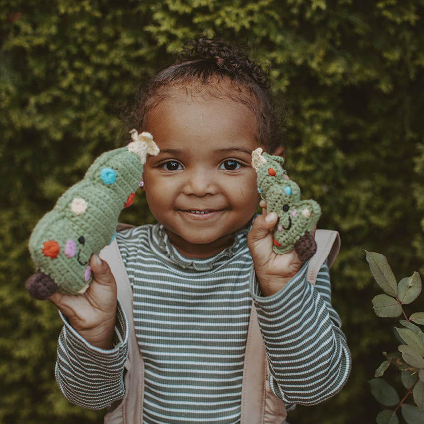 Girl holding matching Christmas Tree Rattle and ornament