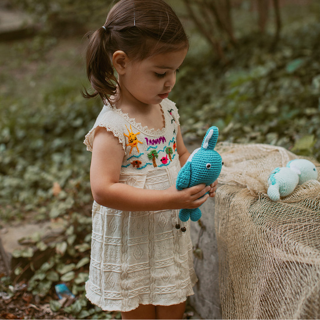 Toddler with fair trade sawfish toy rattle