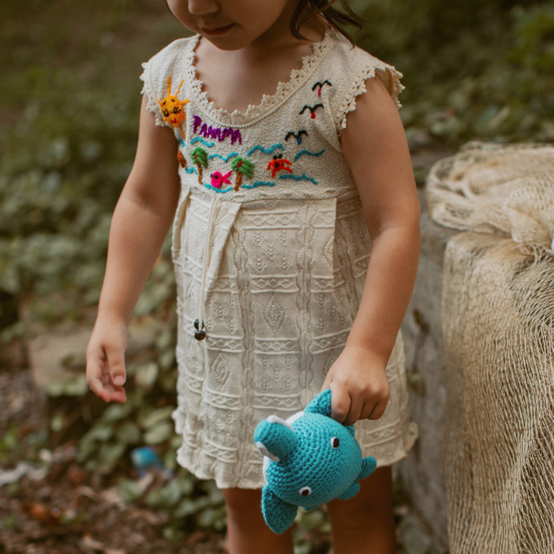 toddler with sawfish stuffed animal toy