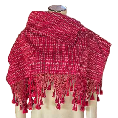 Red knitted shawl with tassels on a mannequin against a white background