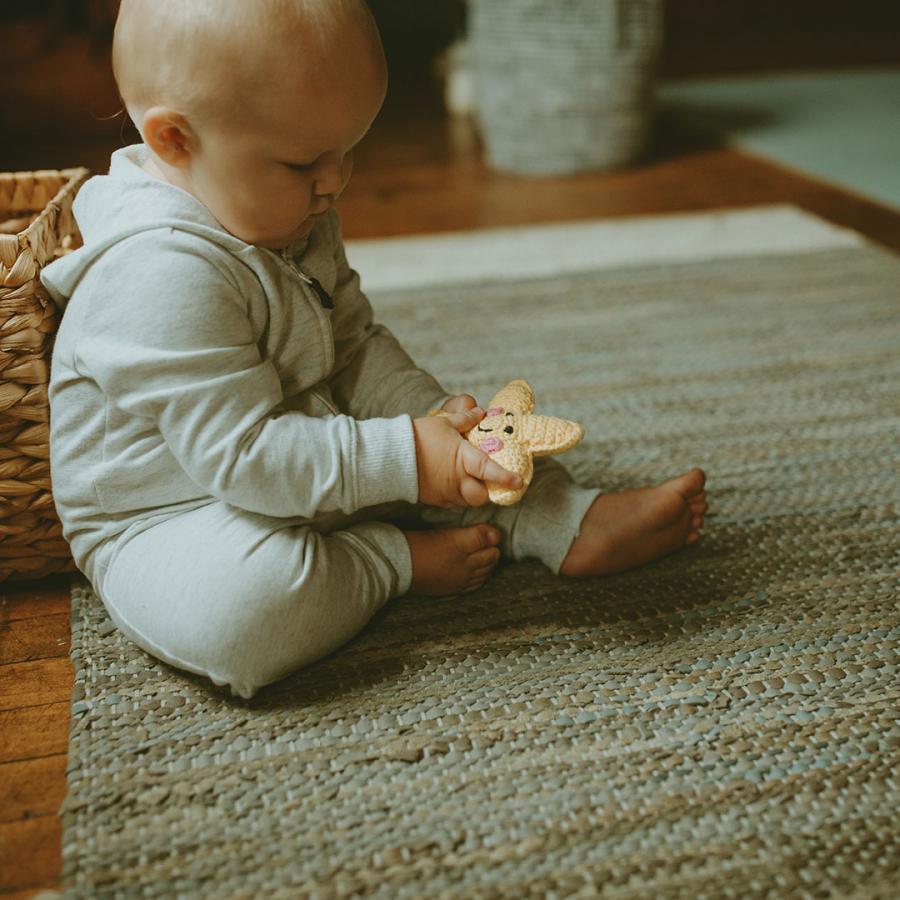 Toddler holding bright yellow plush star baby toy