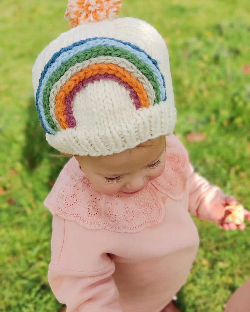 toddler wearing wool rainbow beanie