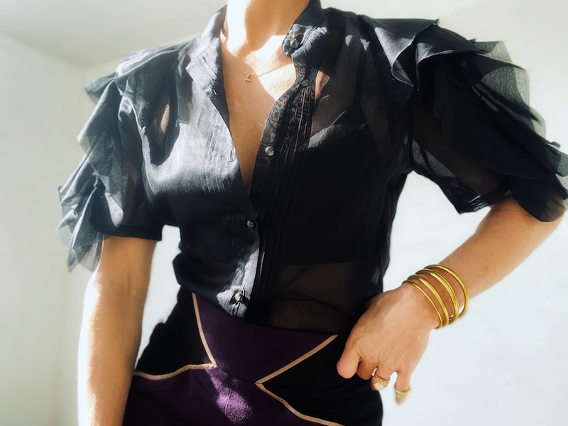 Woman's semi-sheer ruffle sleeve top.