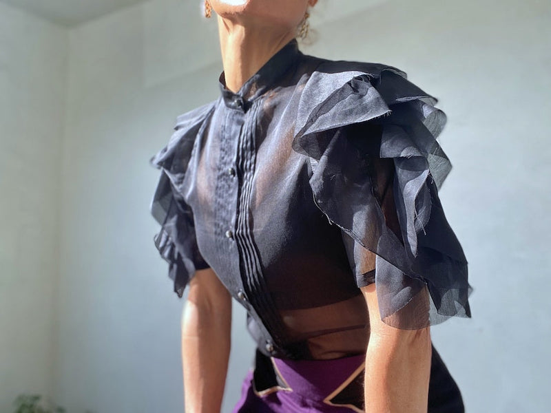 Woman's mock neck semi-sheer silk top.